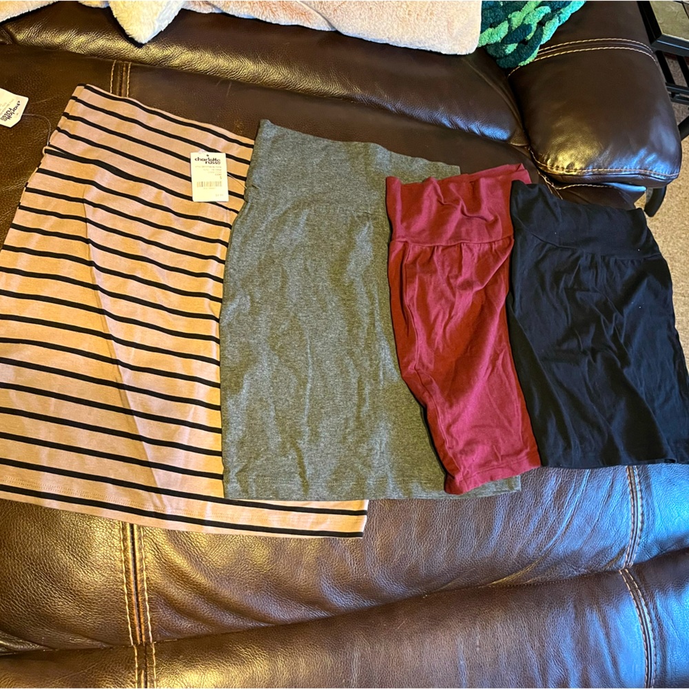 4 pack skirts. 2 with tags. Never worn. Size S. Striped one is size L.